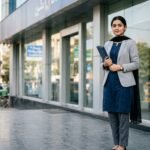 Bank Jobs in Pakistan 2026 – Fresh Graduates Ke Liye Best Options illustrated by a graduate outside a bank building